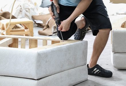 Upholstery being fitted to a furniture frame