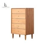 Natural cherry wood five-drawer chest with brass pulls and tapered legs