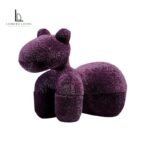 Deep purple sculptural animal lounge chair with textured upholstery