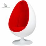 White egg-shaped swivel lounge chair with red upholstered interior