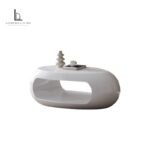 Sculptural white oval coffee table with high-gloss finish and open storage