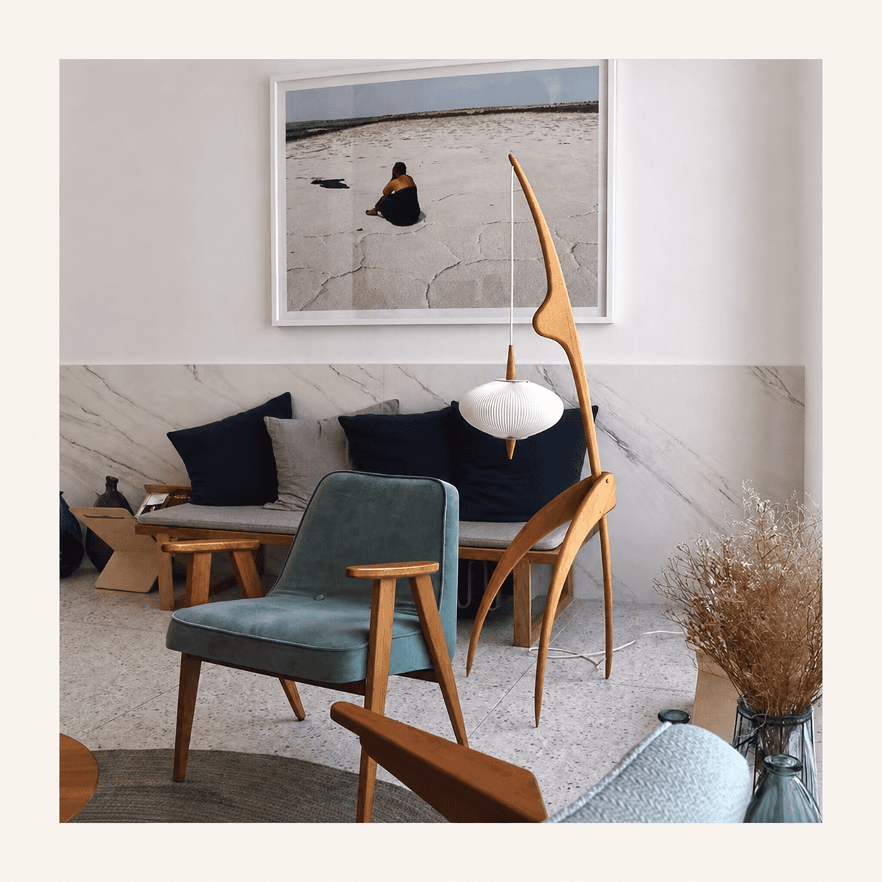 Sculptural wooden hanging floor lamp in a modern living room